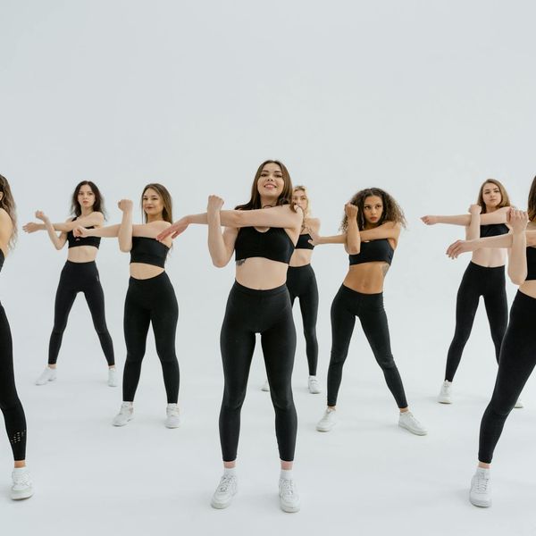 Group of people practicing yoga in a bright studio.